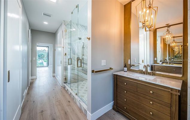 Bathroom, Chandelier, Glass Shower, Interior, Marble Walls, Recessed Lighting, Wood Texture Flooring