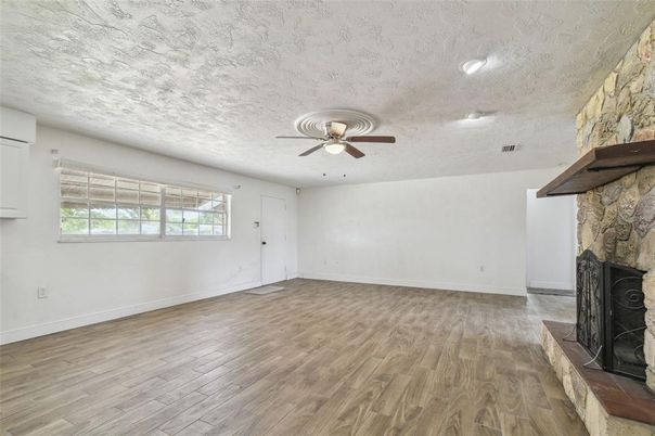 Empty room, Fireplace, Interior, Recessed Lighting, Stone Walls, Wood Texture Flooring