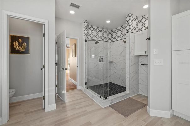 Bathroom, Glass Shower, Interior, Marble Walls, Recessed Lighting, Wood Texture Flooring