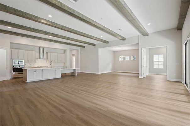 Empty room, Interior, Kitchen, Pendant Lights, Recessed Lighting, Stainless Steel Appliances, Wooden Beams, Wood Texture Flooring