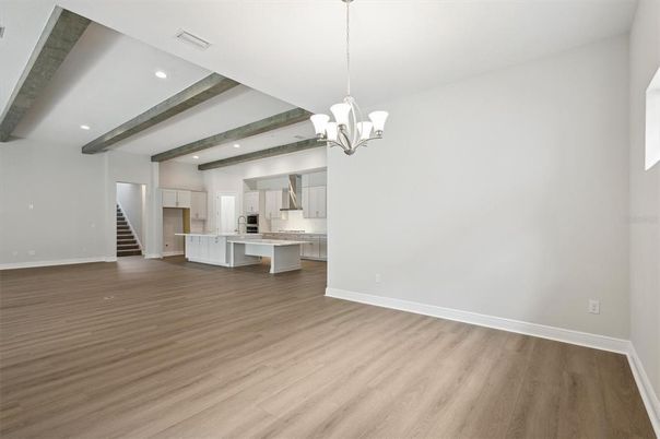 Chandelier, Empty room, Interior, Kitchen, Recessed Lighting, Stainless Steel Appliances, Wooden Beams, Wood Texture Flooring