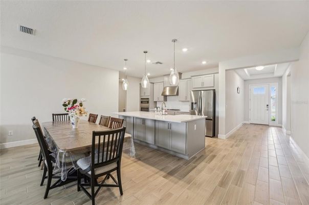 Dining room, Interior, Kitchen, Pendant Lights, Recessed Lighting, Stainless Steel Appliances, Wood Texture Flooring