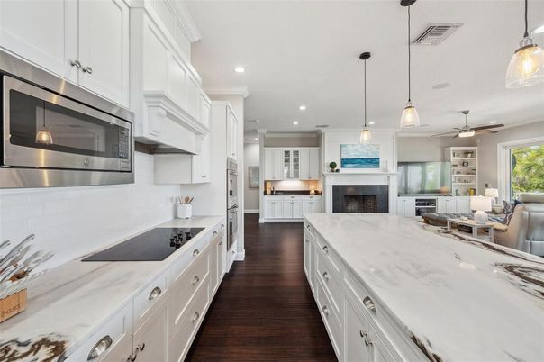 Fireplace, Interior, Kitchen, Living room, Pendant Lights, Recessed Lighting, Stainless Steel Appliances, Wood Texture Flooring