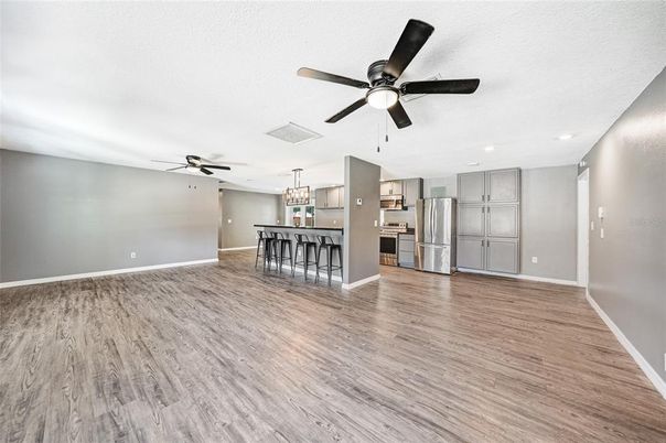 Empty room, Interior, Kitchen, Pendant Lights, Recessed Lighting, Stainless Steel Appliances, Wood Texture Flooring