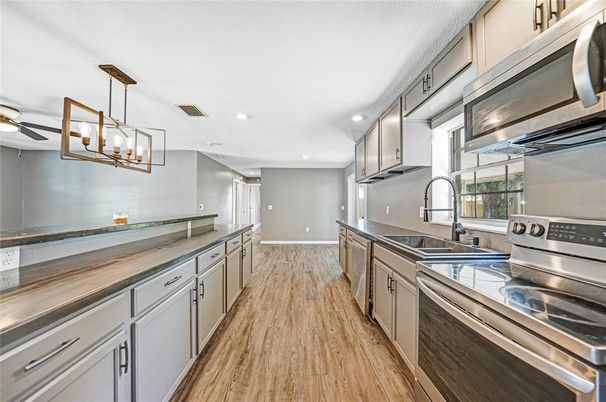 Chandelier, Interior, Kitchen, Pendant Lights, Recessed Lighting, Stainless Steel Appliances, Wood Texture Flooring
