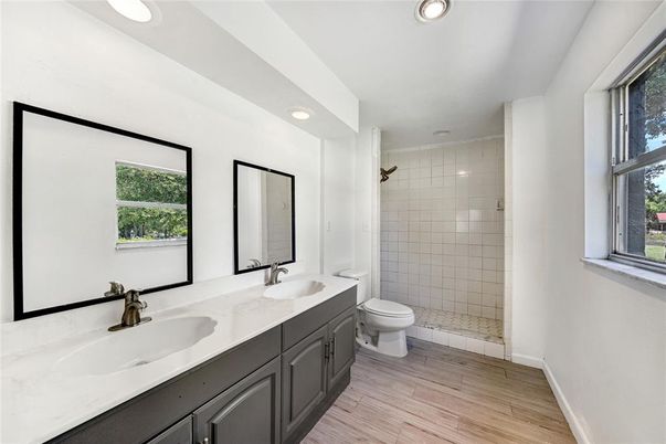 Bathroom, Dual Sink Vanities, Glass Shower, Interior, Recessed Lighting, Wood Texture Flooring