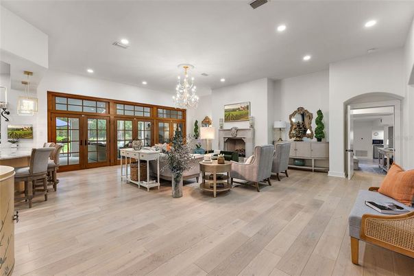 Chandelier, Dining room, Fireplace, Interior, Living room, Pendant Lights, Recessed Lighting, Wood Texture Flooring
