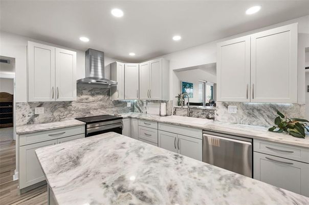Interior, Kitchen, Marble Walls, Recessed Lighting, Stainless Steel Appliances, Wood Texture Flooring