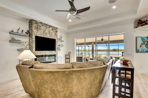 Fireplace, Interior, Living room, Recessed Lighting, Stone Walls, Water, Wood Texture Flooring