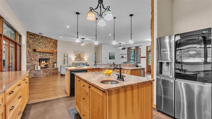 Fireplace, Interior, Kitchen, Living room, Pendant Lights, Recessed Lighting, Stainless Steel Appliances, Stone Walls, Wood Texture Flooring