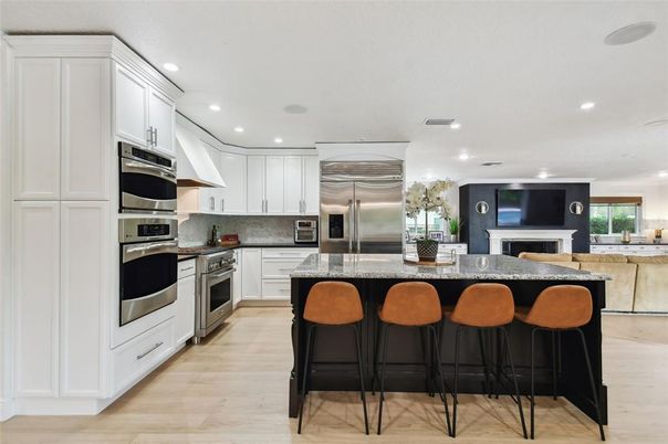 Fireplace, Interior, Kitchen, Recessed Lighting, Stainless Steel Appliances, Wood Texture Flooring