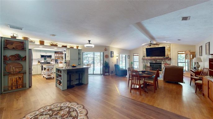Dining room, Fireplace, Interior, Kitchen, Living room, Pendant Lights, Stainless Steel Appliances, Wood Texture Flooring