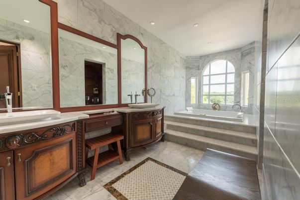 Bathroom, Dual Sink Vanities, Interior, Marble, Marble Walls, Recessed Lighting, Wood Texture Flooring