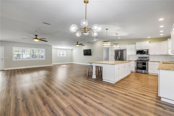Empty room, Interior, Kitchen, Pendant Lights, Recessed Lighting, Stainless Steel Appliances, Wood Texture Flooring