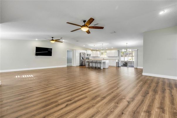 Empty room, Interior, Kitchen, Pendant Lights, Recessed Lighting, Stainless Steel Appliances, Wood Texture Flooring