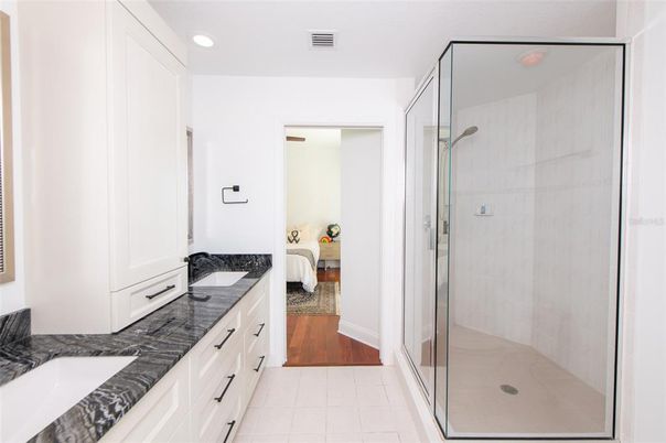 Bathroom, Bedroom, Dual Sink Vanities, Glass Shower, Interior, Recessed Lighting, Wood Texture Flooring