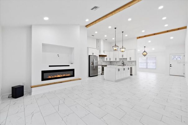 Fireplace, Interior, Kitchen, Marble, Pendant Lights, Recessed Lighting, Stainless Steel Appliances, Wooden Beams
