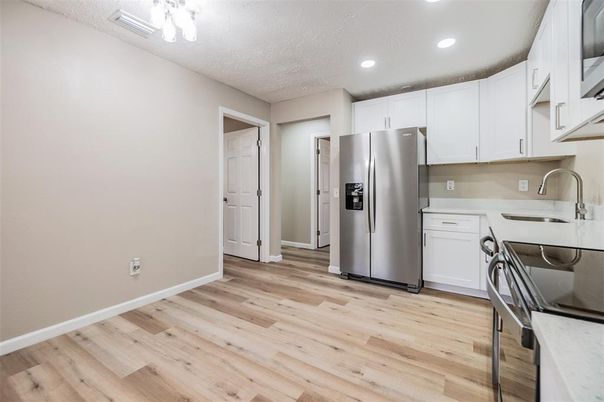 Interior, Kitchen, Recessed Lighting, Washer, Wood Texture Flooring