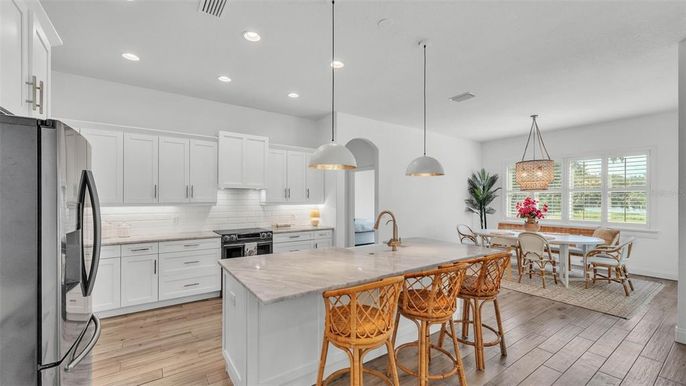 Dining room, Interior, Kitchen, Pendant Lights, Recessed Lighting, Stainless Steel Appliances, Wood Texture Flooring