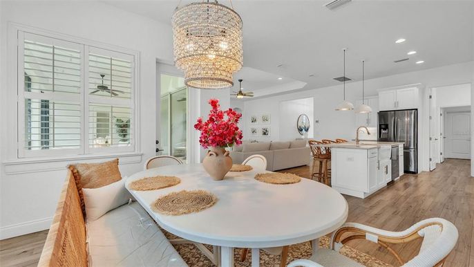 Chandelier, Dining room, Interior, Kitchen, Living room, Pendant Lights, Recessed Lighting, Stainless Steel Appliances, Wood Texture Flooring