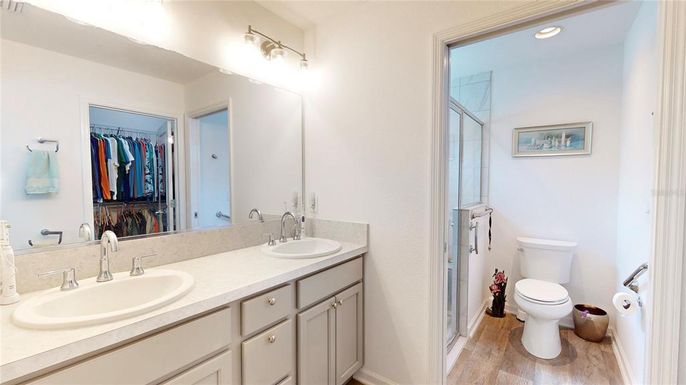 Bathroom, Dual Sink Vanities, Interior, Recessed Lighting, Walk-in Closets, Wood Texture Flooring