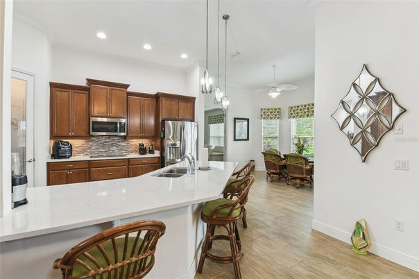 Dining room, Interior, Kitchen, Pendant Lights, Recessed Lighting, Stainless Steel Appliances, Wood Texture Flooring