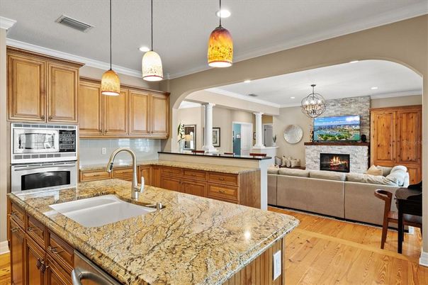 Chandelier, Fireplace, Interior, Kitchen, Living room, Pendant Lights, Recessed Lighting, Wood Texture Flooring