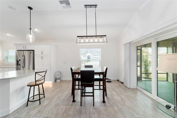 Dining room, Interior, Kitchen, Pendant Lights, Recessed Lighting, Stainless Steel Appliances, Wood Texture Flooring