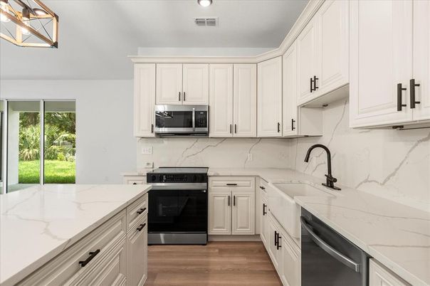 Interior, Kitchen, Marble Walls, Recessed Lighting, Stainless Steel Appliances, Wood Texture Flooring