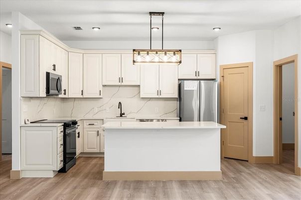 Interior, Kitchen, Marble Walls, Pendant Lights, Recessed Lighting, Stainless Steel Appliances, Wood Texture Flooring