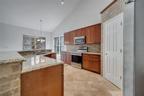 Interior, Kitchen, Pendant Lights, Stainless Steel Appliances, Stone Walls