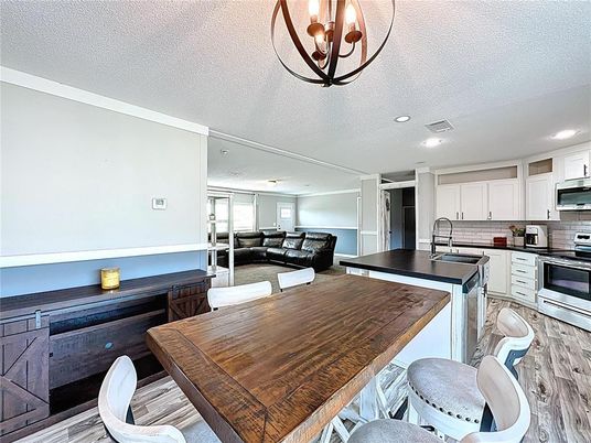Chandelier, Dining room, Interior, Kitchen, Living room, Recessed Lighting, Stainless Steel Appliances, Wood Texture Flooring