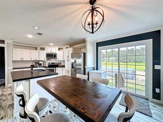 Chandelier, Dining room, Interior, Kitchen, Recessed Lighting, Stainless Steel Appliances, Wood Texture Flooring