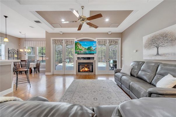 Chandelier, Dining room, Fireplace, Interior, Living room, Pendant Lights, Recessed Lighting, Wood Texture Flooring