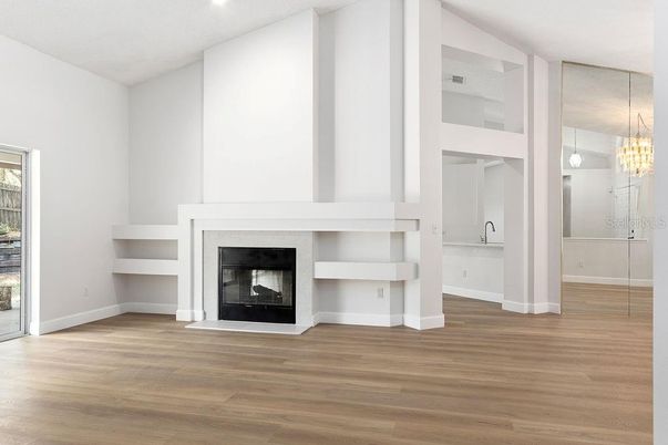 Chandelier, Empty room, Fireplace, Interior, Pendant Lights, Recessed Lighting, Wood Texture Flooring