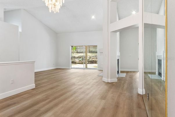 Chandelier, Empty room, Fireplace, Interior, Recessed Lighting, Wood Texture Flooring