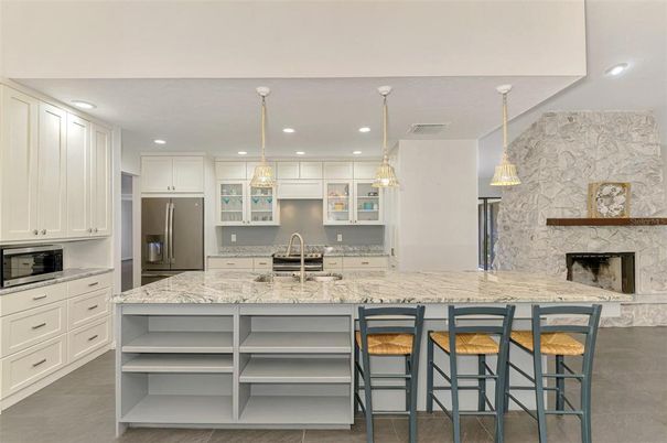 Fireplace, Interior, Kitchen, Pendant Lights, Recessed Lighting, Stainless Steel Appliances, Stone Walls