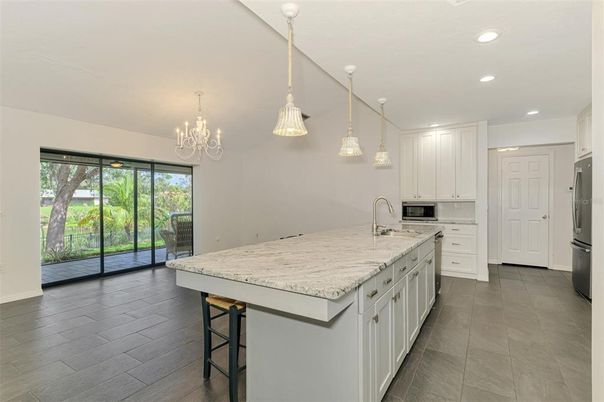 Chandelier, Interior, Kitchen, Pendant Lights, Recessed Lighting, Stainless Steel Appliances, Wood Texture Flooring