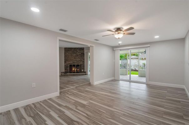 Empty room, Fireplace, Interior, Recessed Lighting, Stone Walls, Wood Texture Flooring