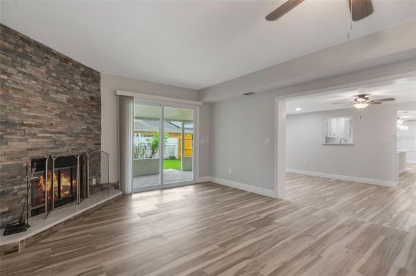 Empty room, Fireplace, Interior, Recessed Lighting, Stone Walls, Wood Texture Flooring