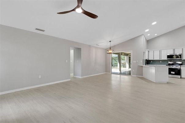 Empty room, Interior, Kitchen, Pendant Lights, Recessed Lighting, Stainless Steel Appliances, Wood Texture Flooring