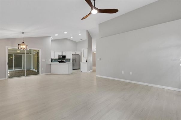 Empty room, Interior, Kitchen, Pendant Lights, Recessed Lighting, Stainless Steel Appliances, Wood Texture Flooring