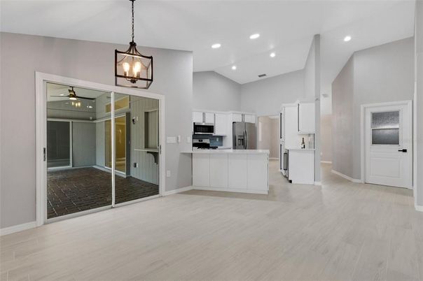 Empty room, Interior, Kitchen, Pendant Lights, Recessed Lighting, Stainless Steel Appliances, Wood Texture Flooring