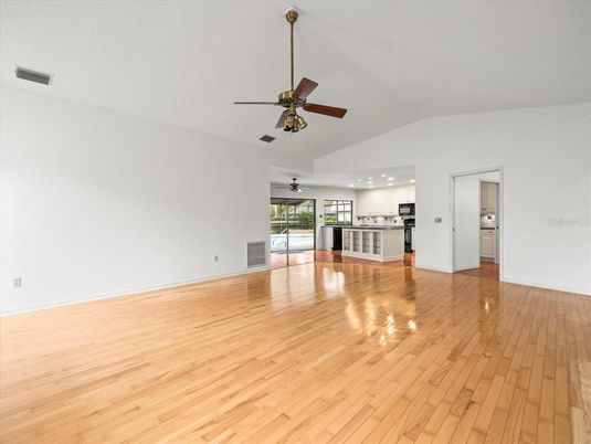 Empty room, Interior, Kitchen, Recessed Lighting, Stainless Steel Appliances, Wood Texture Flooring