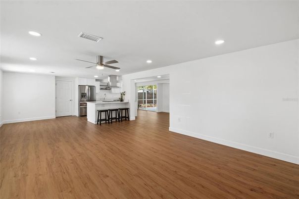 Empty room, Interior, Kitchen, Recessed Lighting, Stainless Steel Appliances, Wood Texture Flooring