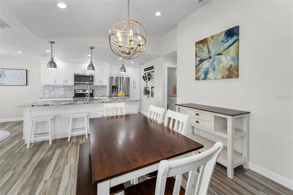 Chandelier, Dining room, Interior, Kitchen, Pendant Lights, Recessed Lighting, Stainless Steel Appliances, Wood Texture Flooring