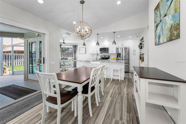 Chandelier, Dining room, Interior, Kitchen, Pendant Lights, Recessed Lighting, Stainless Steel Appliances, Wood Texture Flooring