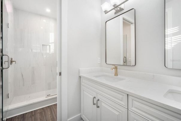 Bathroom, Dual Sink Vanities, Glass Shower, Interior, Recessed Lighting, Wood Texture Flooring