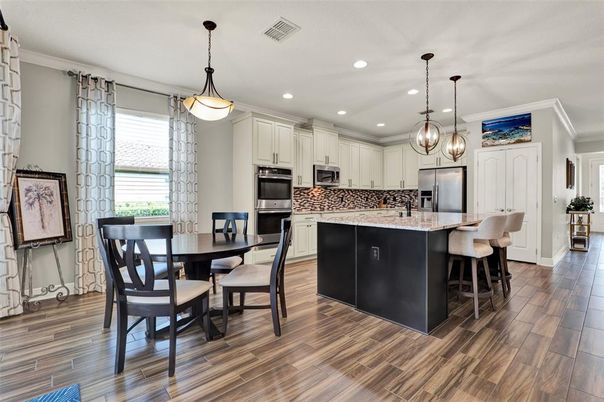 Dining room, Interior, Kitchen, Pendant Lights, Recessed Lighting, Stainless Steel Appliances, Wood Texture Flooring