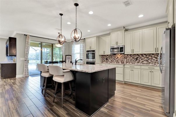 Dining room, Interior, Kitchen, Pendant Lights, Recessed Lighting, Stainless Steel Appliances, Wood Texture Flooring